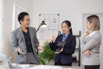 Asian business teamwork working on digital tablet with analysis report and advisor showing plan, Financial analysis and Marketing teamwork concept.