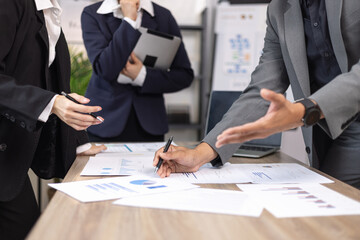 Asian business teamwork working on digital tablet with analysis report and advisor showing plan, Financial analysis and Marketing teamwork concept.