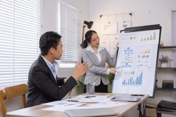 Two business people working with business financing accounting banking and laptop with finances analysis report at desk in office. 