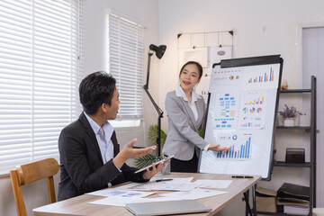 Two business people working with business financing accounting banking and laptop with finances analysis report at desk in office. 
