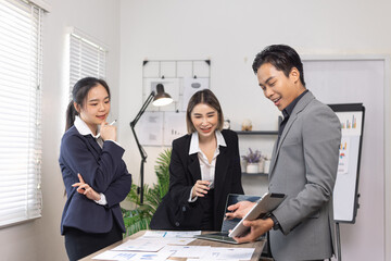 Asian business teamwork working on digital tablet with analysis report and advisor showing plan, Financial analysis and Marketing teamwork concept.