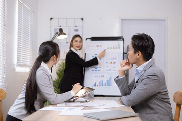 Asian business teamwork working on digital tablet with analysis report and advisor showing plan, Financial analysis and Marketing teamwork concept.