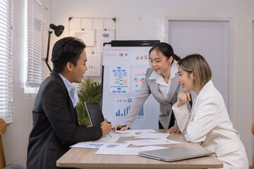 Asian business teamwork working on digital tablet with analysis report and advisor showing plan, Financial analysis and Marketing teamwork concept.