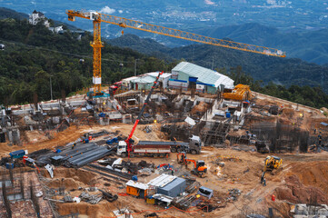 A construction site with a crane and an excavator. Development of a foundation pit for a building...