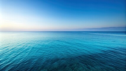 Obraz premium A serene seascape featuring an expansive blue ocean under a clear azure sky, showcasing the tranquility of nature.