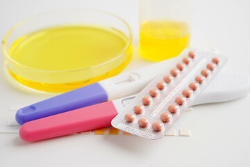 Urinalysis, pregnancy test and urine cup for female of ovulation day, fetus, maternity, childbirth, birth control.