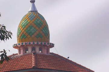 view of the mosque dome with a white sky background