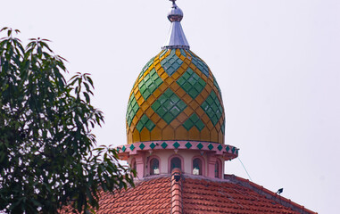 view of the mosque dome with a white sky background