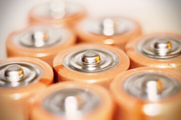 Close up of positive ends of discharged batteries of different sizes and formats, selective focus....