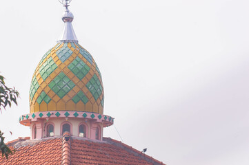 view of the mosque dome with a white sky background