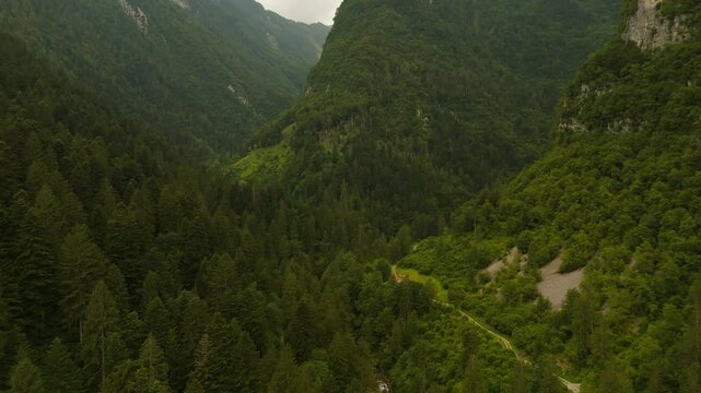 A peaceful village hidden among the Dolomite mountains from above.