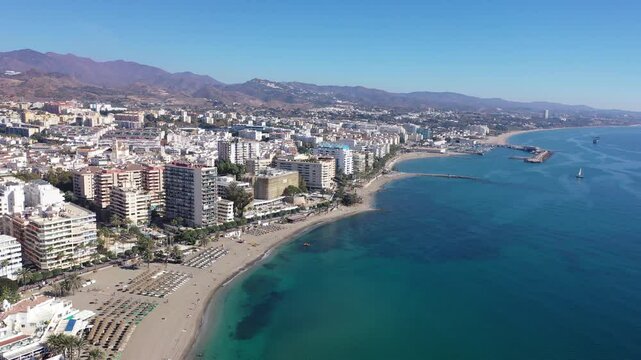 Scenic aerial view of Spanish tourist town of Marbella on Mediterranean coast with harbour on sunny autumn day, province of Malaga