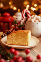 Cake surrounded by festive decorations, creating a cozy holiday vibe. Perfect for Christmas, holiday season, or festive celebrations. Keywords: Christmas cake, holiday food.