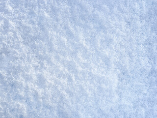 Winter background with snow patterns. Abstract background. The natural texture of snow. The surface of clean fresh snow. Panorama. Close-up view from above. New Year's background. Copy space