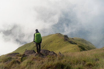 Traveler sightseeing the beautiful scenery of nature and mist during time the sunrise