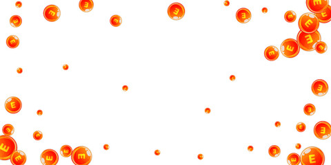 Vitamin E round capsules scattered randomly.