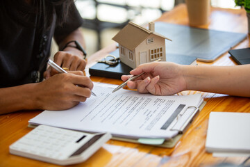 Closeup shot of business woman's hand using pen and writing in computer notebook business calculations or a female student using a computer The phone works for
 Exam preparation, presentations