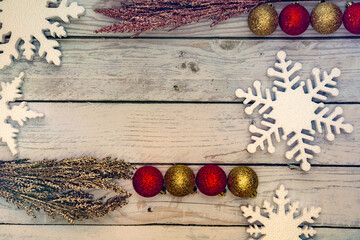 Christmas decorations on a wooden background:  balls, branches, snowflakes, top view, copyspace