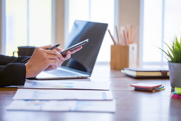 Closeup shot of business woman's hand using pen and writing in computer notebook business calculations or a female student using a computer The phone works for
 Exam preparation, presentations