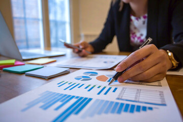 Closeup shot of business woman's hand using pen and writing in computer notebook business calculations or a female student using a computer The phone works for
 Exam preparation, presentations