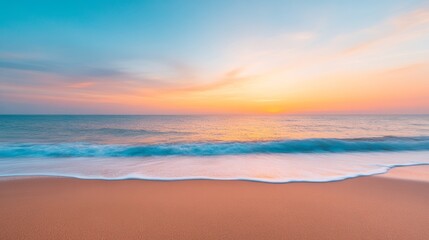 Obraz premium A tranquil beachfront at sunrise with gentle waves lapping the shore and a colorful sky reflecting the day's awakening