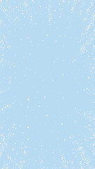 Snowy christmas background. Subtle flying snow flakes and stars on light blue winter backdrop. Delicate sweet snowy christmas. Vertical vector illustration.