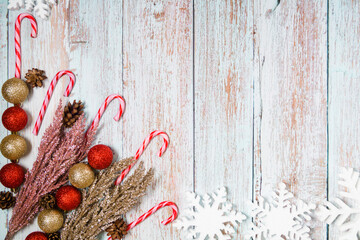 Christmas decorations on a wooden background: Christmas tree balls, branches, snowflakes and candy...