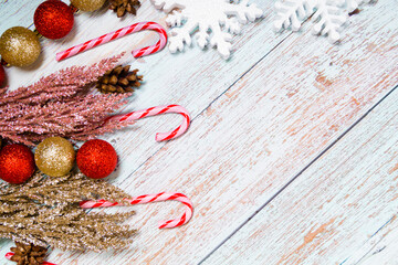 Christmas decorations on a wooden background: Christmas tree balls, branches, snowflakes and candy...