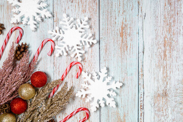 Christmas decorations on a wooden background: Christmas tree balls, branches, snowflakes and candy...