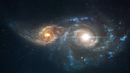 Two galaxies are merging together. Amazing Space galaxy, blue starry background. View from space to...