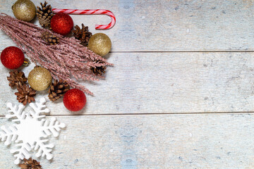 Christmas decorations on a wooden background: Christmas tree balls, branches, snowflakes and candy...
