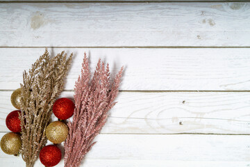 Christmas decorations on a wooden background: Christmas tree balls, branches, snowflakes and candy...