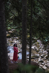 Woman in Red Dress by Serene Forest River