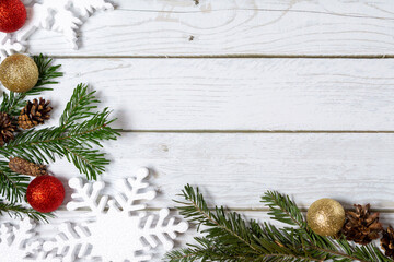 Christmas decorations on a wooden background: Christmas tree balls, branches, snowflakes and candy...