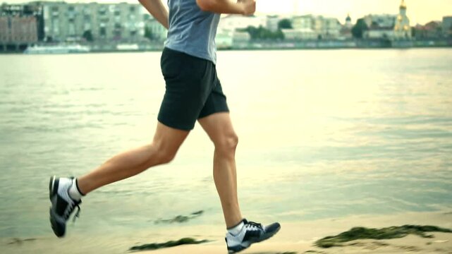 Man jogging along riverbank . Morning urban setting