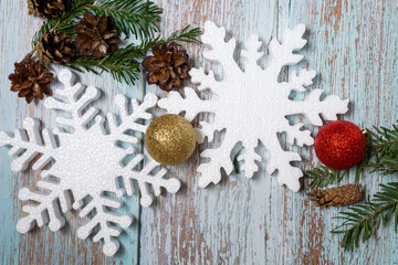 Christmas decorations on a wooden background: Christmas tree balls, branches, snowflakes and candy...