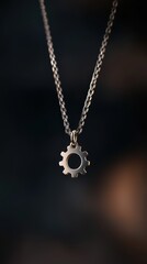 Fototapeta premium Stylish gear pendant necklace on a dark background, highlighting unique design and craftsmanship.