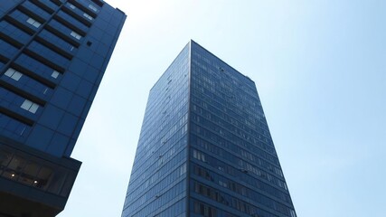 Modern office building standing tall with a clear blue sky in the background, exterior, building, corporate