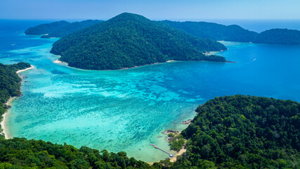 The aerial view of white sand beach tropical with seashore as the island in a coral reef ,blue and...