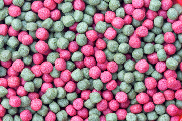 red and green pellets staple food for commercial fish pets