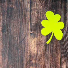 Clover leafs on wooden background, top view, copy space. Concept of luck St. Patrick's Day