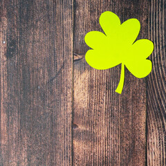 Clover leafs on wooden background, top view, copy space. Concept of luck St. Patrick's Day
