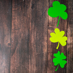 Clover leafs on wooden background, top view, copy space. Concept of luck St. Patrick's Day