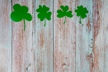 Clover leafs on wooden background, top view, copy space. Concept of luck St. Patrick's Day