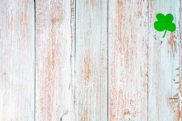Clover leafs on wooden background, top view, copy space. Concept of luck St. Patrick's Day