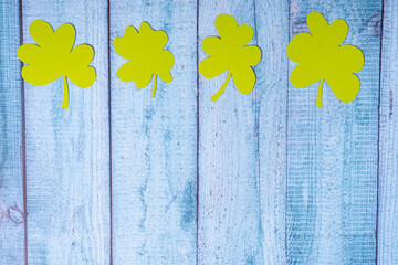 Green four leaf clovers on wooden background top view. Happy St. Patrick's Day greetings © Mikhail Taratonov