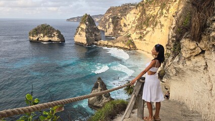 woman in a white dress on a paradise beach

