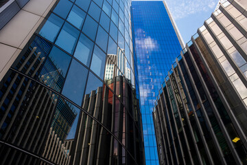 The interplay of reflections in the glass surfaces of skyscrapers creates a stunning visual harmony, capturing the essence of urban life and architectural beauty.