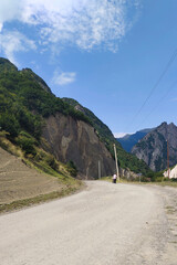 a road between high rocky mountains and an abyss