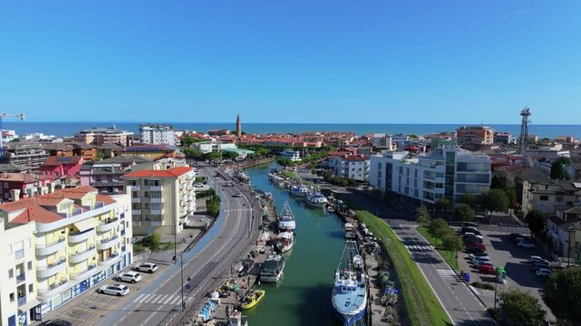 aerial flight down the Porto di Caorle lined with commercial fishing boats on the Adriatic Sea